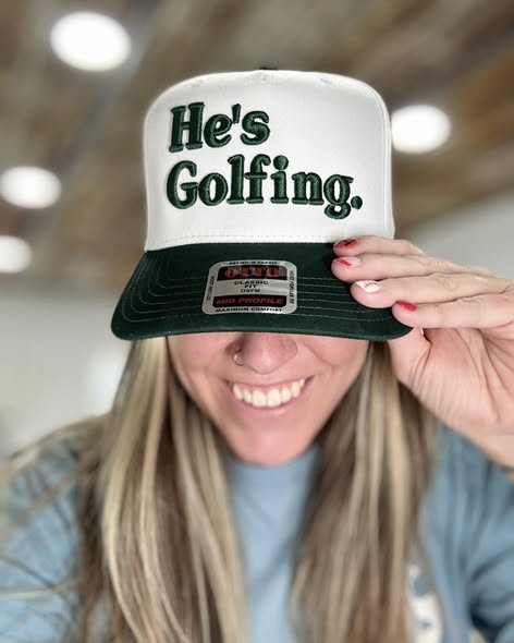 He's Golfing Trucker Hat